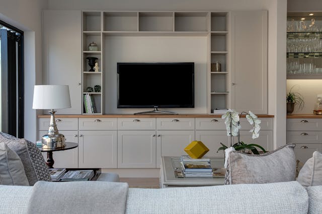 a built in entertainment system in a white living room