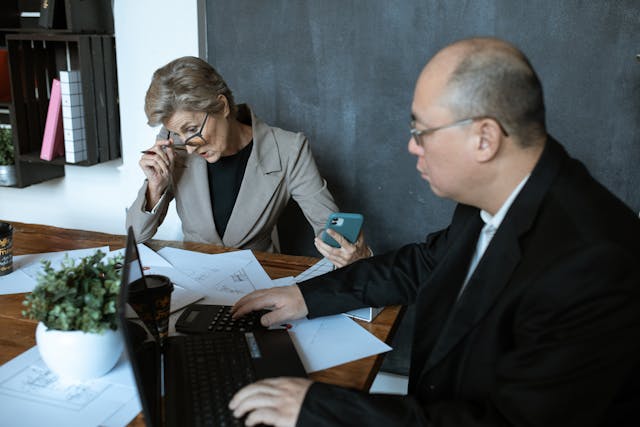 two people looking over contracts in a conference room